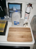 water jug sink covered by cutting board