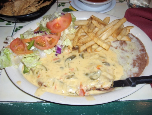 Milanesa steak topped with chile con queso