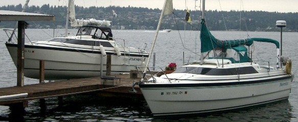 Mac26x on lift showing belly and  
Mac26x in water, belly providing foredeck stability exceeding the M and classics