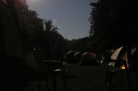 wrestlers' tents illuminated 
solely by full moon